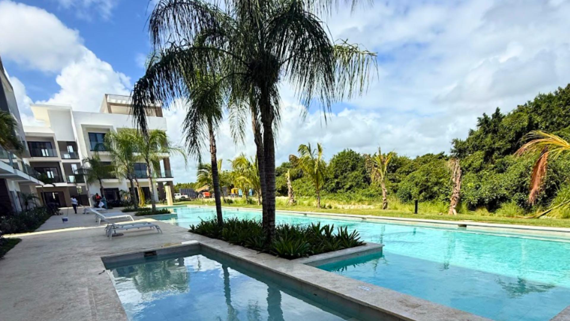 Captivating apartment with high-end finishes, pool, and private beach in a tropical paradise